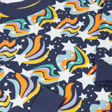 A close up of the print on the Frugi child's Organic Cotton Mawnan Jumper with a Magic Skies print. A navy background with white stars and rainbow swirls all over. This jumper is a part of a wide range of organic cotton clothing for children available here at Babipur. 
