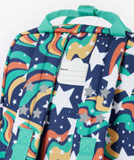 A close up of the back of the Frugi magic stars explorer backpack showing the name tag detail on the top of the bag in between the shoulder straps.