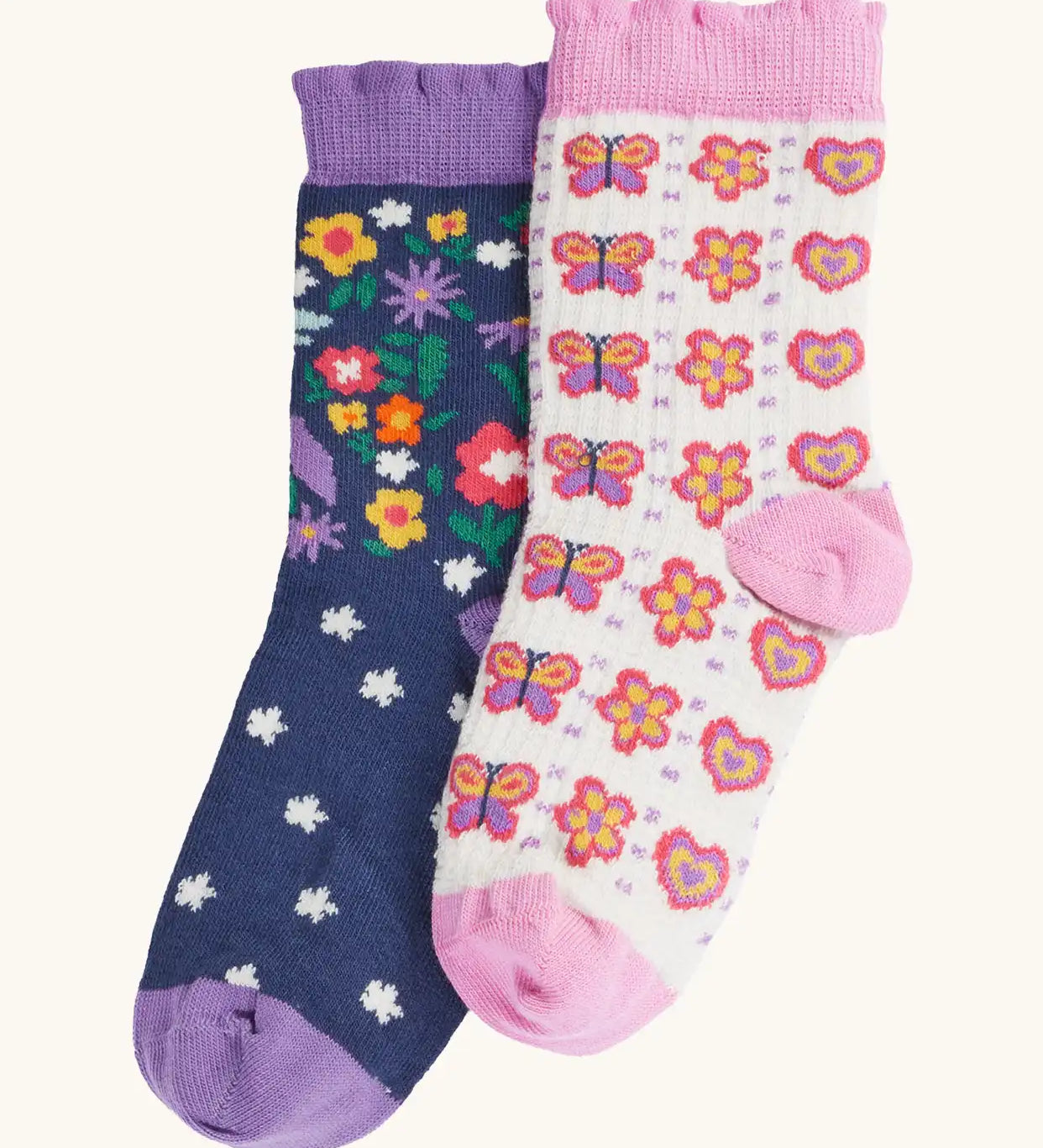 Frugi magical organic cotton frill socks 2 pack. One navy pair with flowers and a pegasus and a purple frill. One white pair with flowers and butterflies with pink frill.