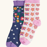 Frugi magical organic cotton frill socks 2 pack. One navy pair with flowers and a pegasus and a purple frill. One white pair with flowers and butterflies with pink frill.