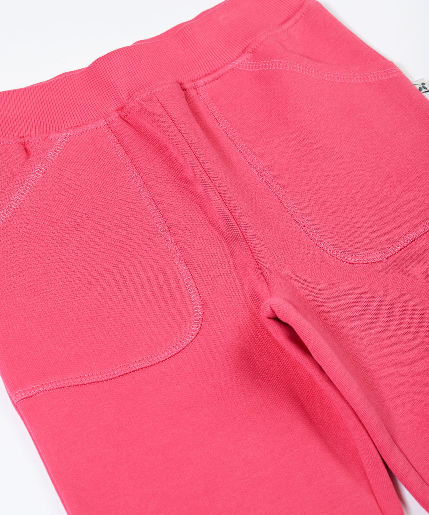 A close up of the pockets on the Frugi Malpas rose pink joggers.
