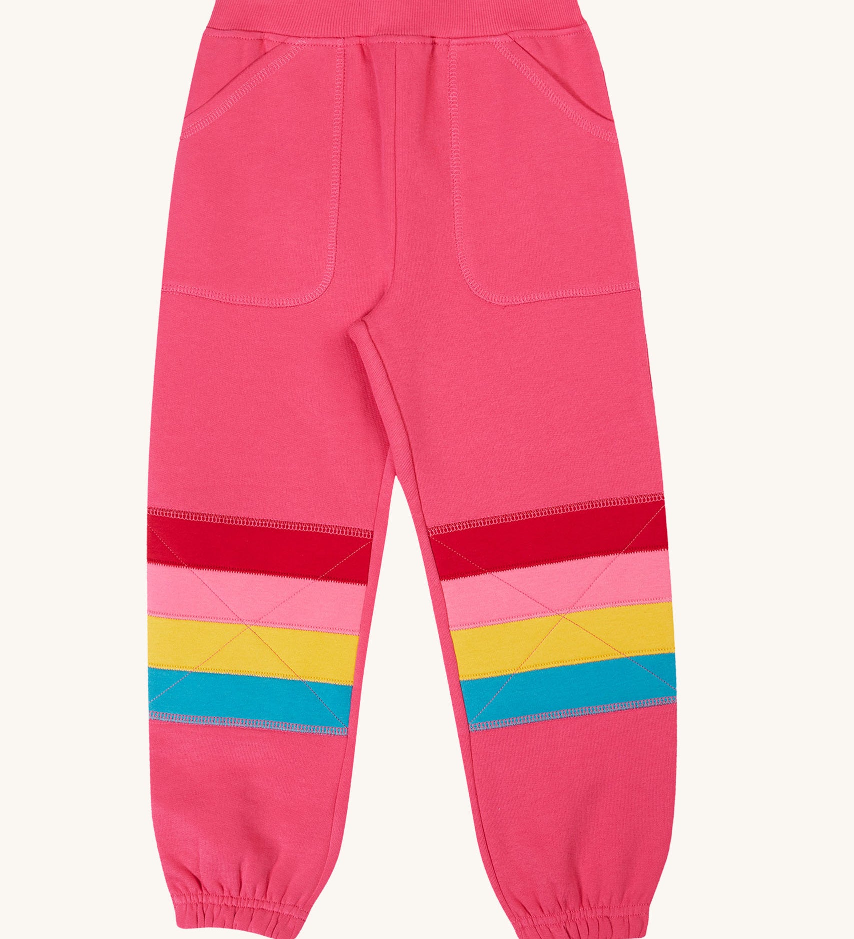 Frugi Malpas rose pink rainbow applique organic cotton joggers. The joggers coordinate with other items from Frugi's Autumn Winter range available at Babipur. 