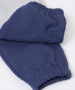 A close up of the navy block colour on the Frugi Malpas Placement Grey Joggers with Trucks.