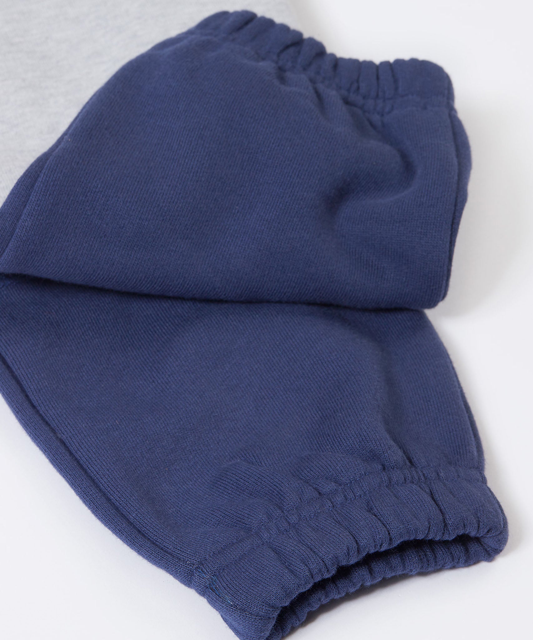 A close up of the navy block colour on the Frugi Malpas Placement Grey Joggers with Trucks.