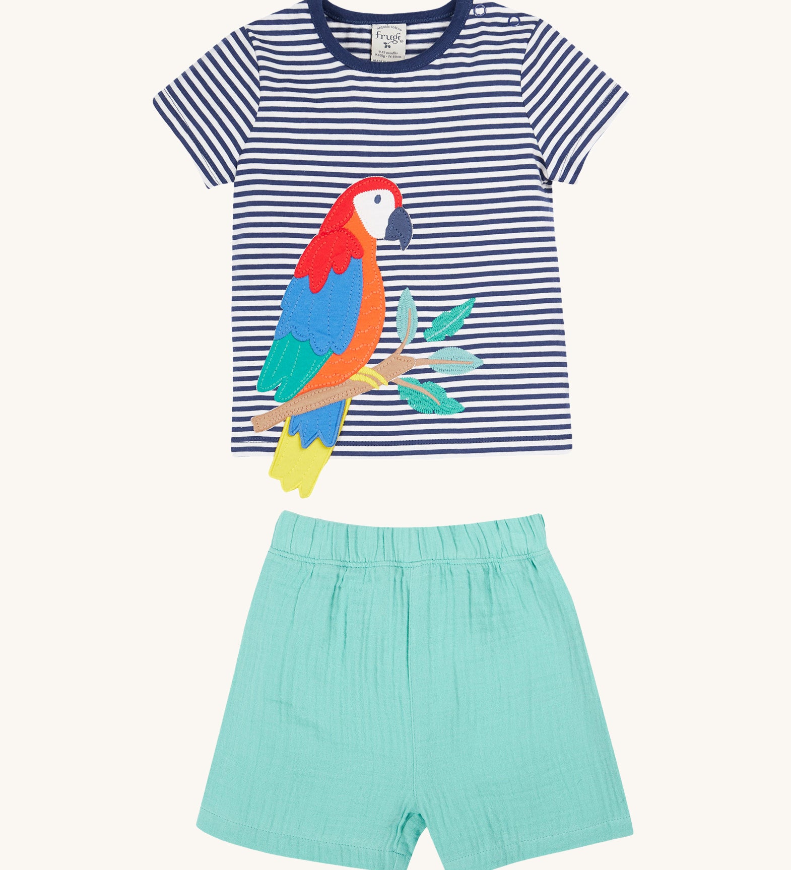 Frugi Marco Outfit laid flat, featuring a  Navy Blue Stripe t-shirt with an embroidered Parrot, and shorts in the colour Moss.