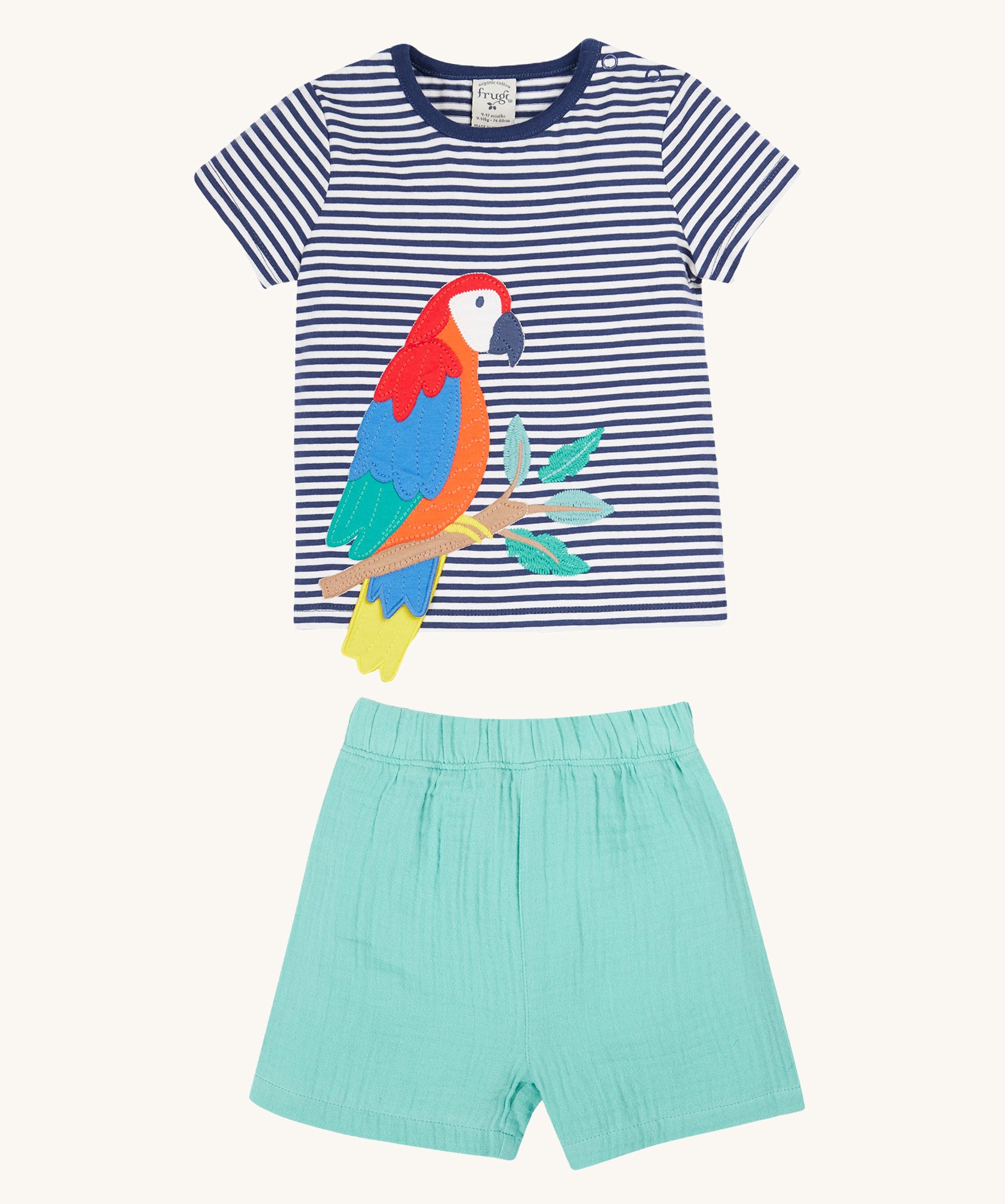 Frugi Marco Outfit laid flat, featuring a  Navy Blue Stripe t-shirt with an embroidered Parrot, and shorts in the colour Moss.