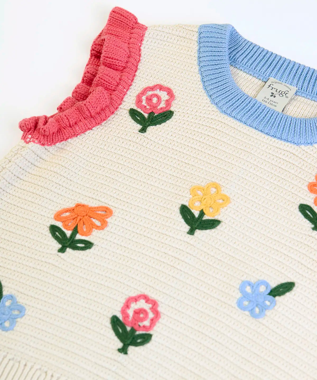 Frugi GOTS 100% organic cotton natural knitted tank top in cream showing a baby blue neck line, pink shoulder cuffs and flower embroideries