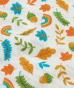 Close up of the autumn acorn print on the Frugi marvellous organic cotton muslin.
