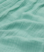 A close up of Frugi Mateo Shorts in the colour Moss.