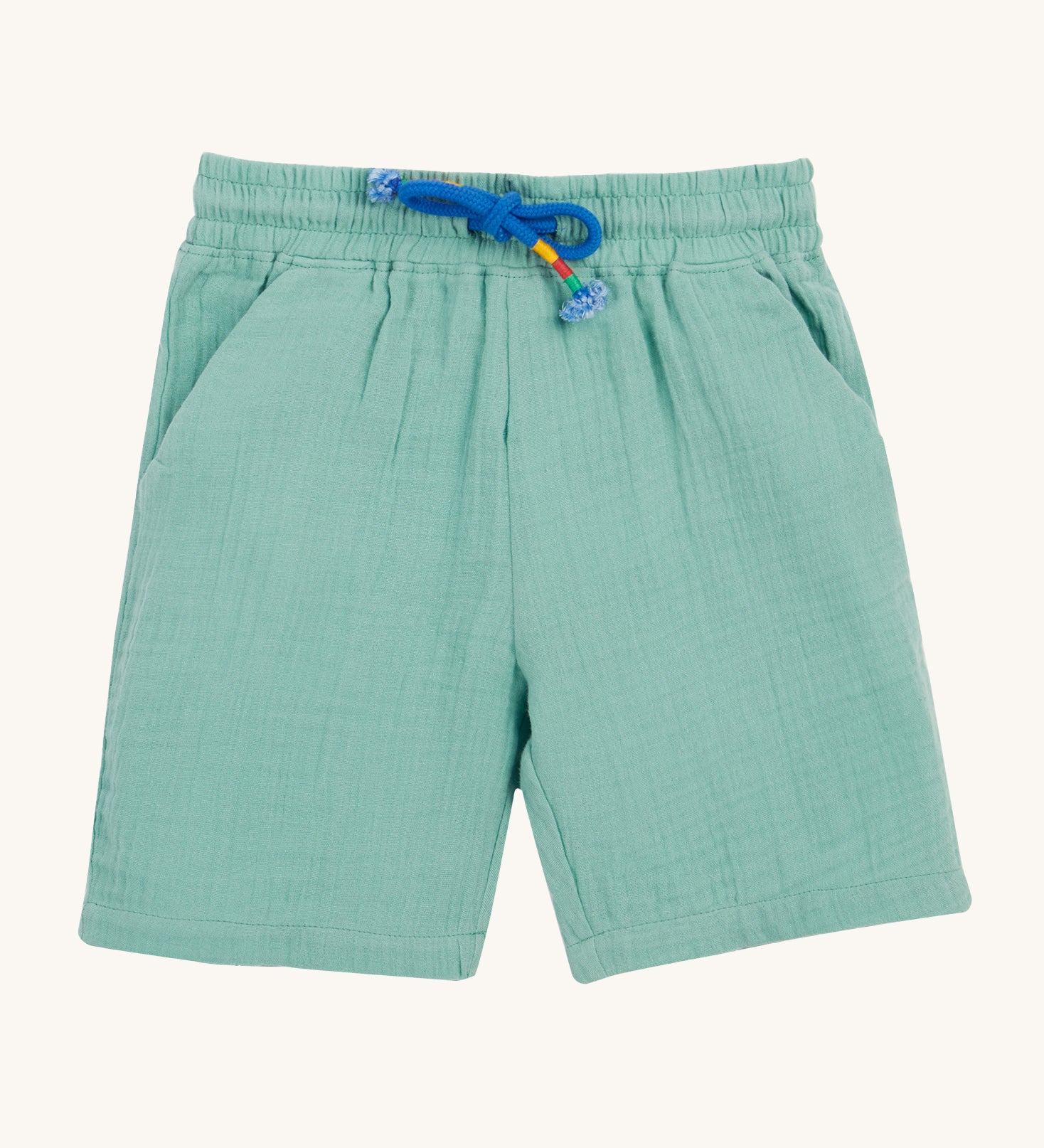 Frugi Mateo Shorts laid flat, in the colour Moss, featuring a blue drawstring and two front pockets.