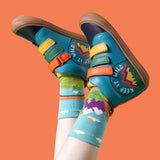A child wearing the Frugi meadow high top leather children's shoes with a keep it wild design on a boat blue colour with Frugi mountain themed organic cotton socks.