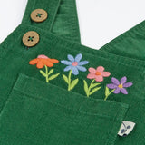 Close up of the embroidered flowers above the pocket on the front of the Frugi Miley holly green cord dungaree.