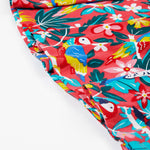 A close up of the bottom of Frugi Morwenna Skater Dress in the Birds Of Paradise print.