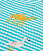 A close up of the Frugi kids moss stripe wildlife t-shirt. Showing the camel applique detail next to the pelican applique on blue and white stripe organic cotton fabric.