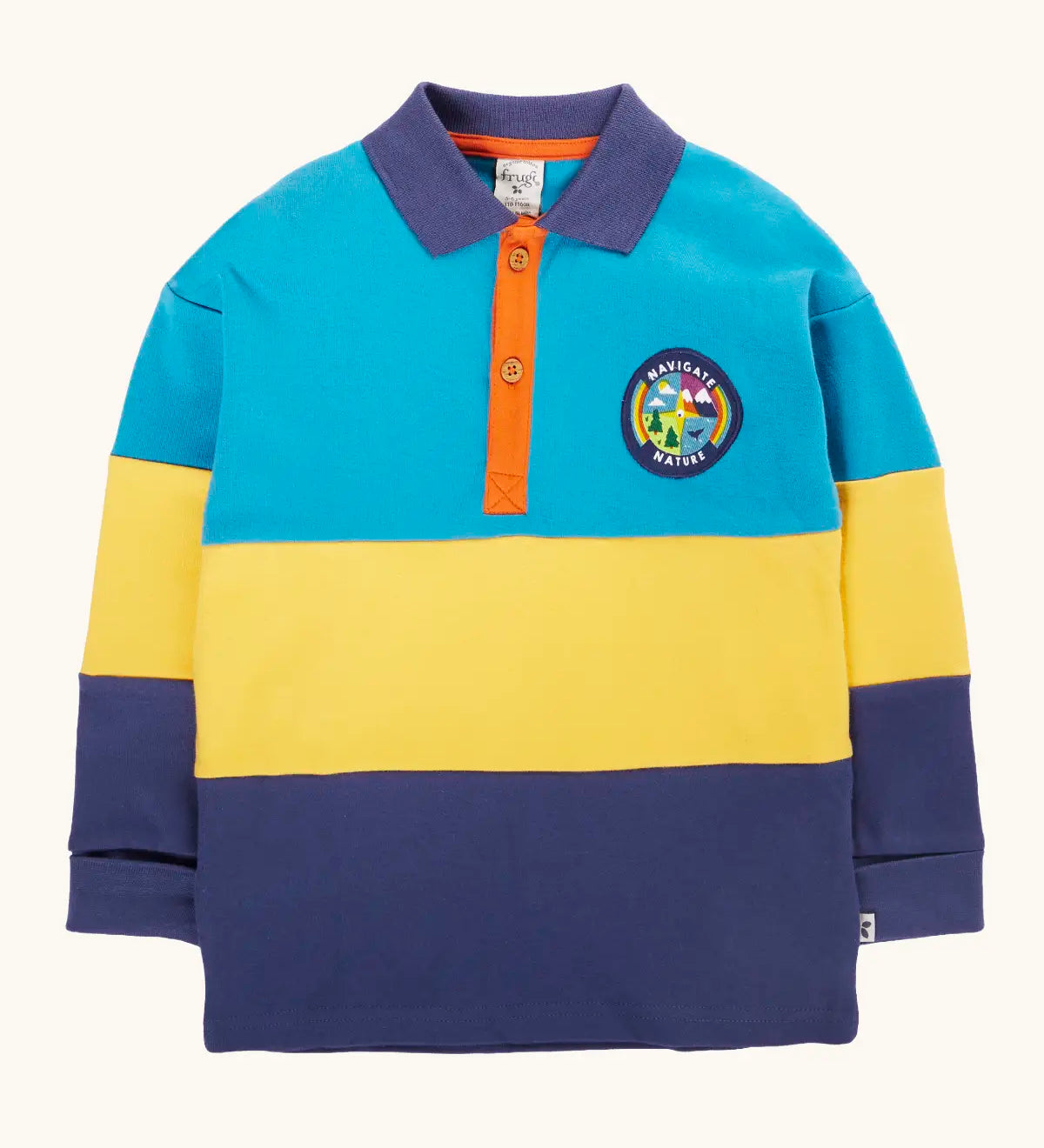 Frugi mullion long sleeve organic cotton rugby top in a hotchpotch colourblock design with a navigate nature circular badge on the chest.