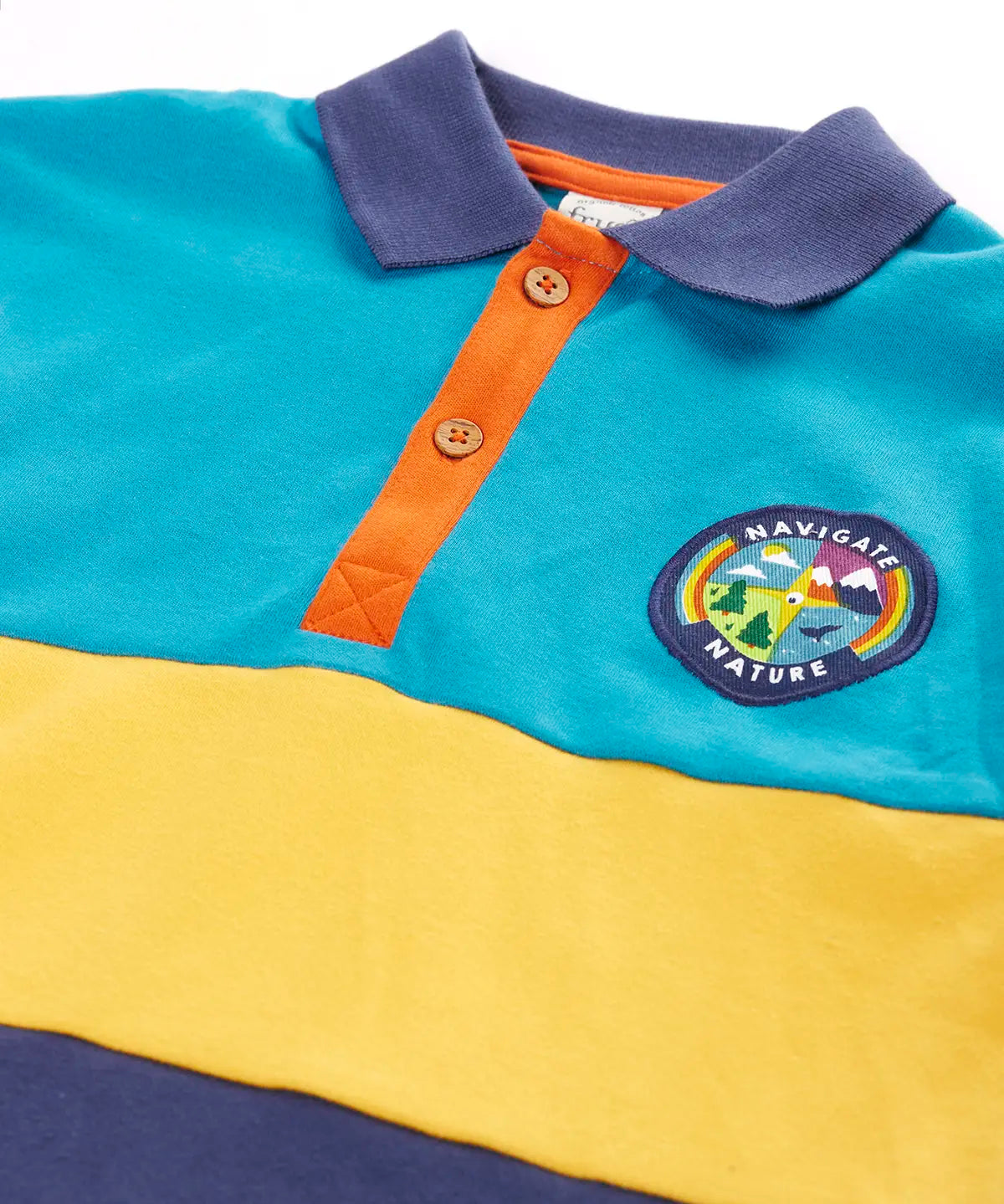 Frugi mullion long sleeve organic cotton rugby top in a hotchpotch colourblock design with a navigate nature circular badge on the chest.