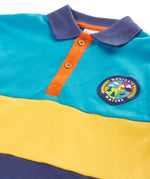 Frugi mullion long sleeve organic cotton rugby top in a hotchpotch colourblock design with a navigate nature circular badge on the chest.