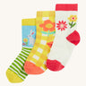 Frugi kids spring 3 pack socks - GOTS organic kids socks which features a white sock with a pink trim and flowers. A yellow gingham sock with a flower design and a green striped sock with a rabbit design.
