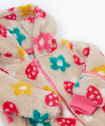 A close up o the Frugi kids recycled cosy snuggle suit in mushroom fields showing the pink zip detail and matching pink cuff on thick warm recycled textile fabric.