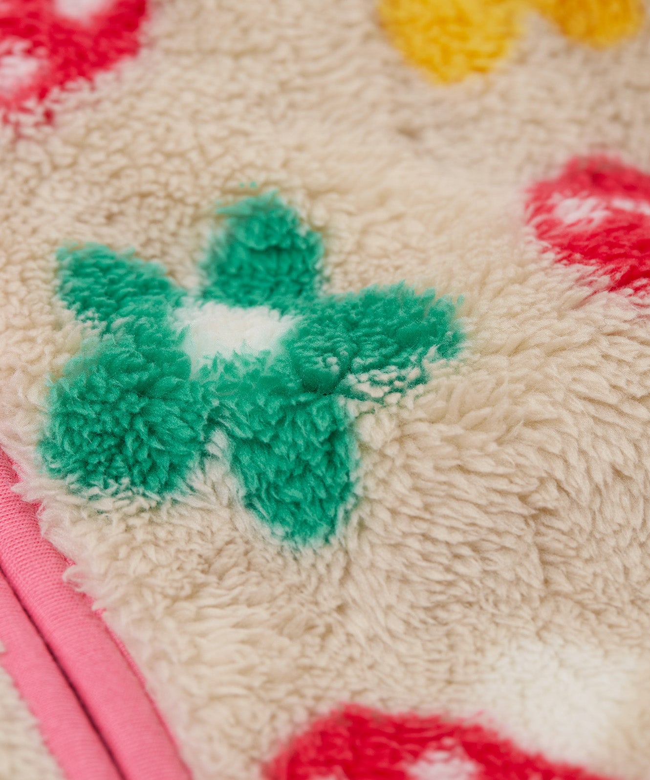A close up of thick fleece detail on the Frugi mushroom field ted stripe fleece 