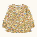 Frugi Natasha long sleeve organic cotton top in yellow with an all over highland houses themed print. Frilled collar and elasticated sleeves.
