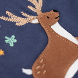 A close up of the reindeer applique on the front of the Frugi Navy Organic Cotton Caris Reindeer Applique Top. This top is a part of a wide range of organic cotton clothing for children available here at Babipur. 