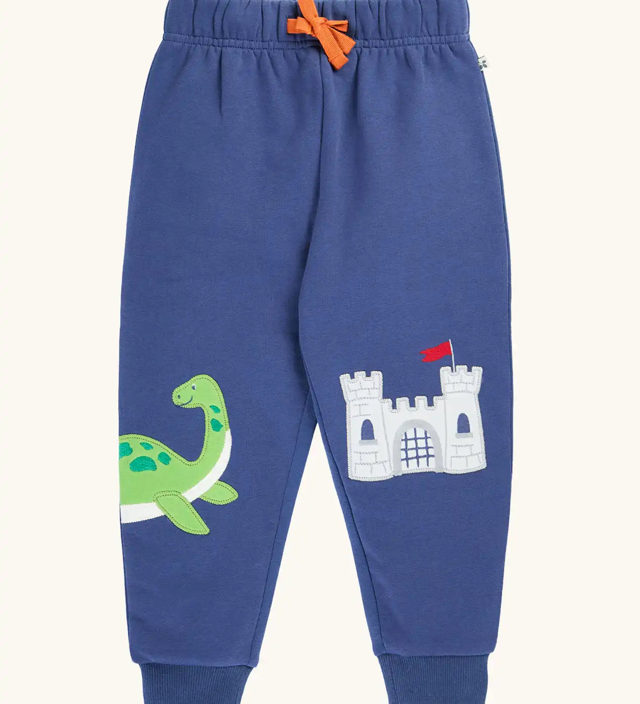 Frugi navy nessie organic cotton kids character joggers, green nessie on one side and castle on the other.
