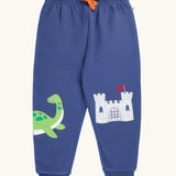 Frugi navy nessie organic cotton kids character joggers, green nessie on one side and castle on the other.