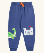 Frugi navy nessie organic cotton kids character joggers, green nessie on one side and castle on the other.