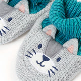 Close up of the Frugi Noa organic cotton knitted baby booties in a grey wild cat design with turquoise lining.