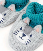 Close up of the Frugi Noa organic cotton knitted baby booties in a grey wild cat design with turquoise lining.