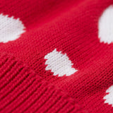 A close up of the Frugi kids noa knitted hat in red mushroom showing the red and white mushroom knit detail on organic cotton fabric