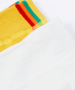 A close up of the waist bands on the Frugi Norah 2 pack tights. the flower design had a plain white waistband whilst the bumble bee yellow tights have a yellow, green, orange and red stripe on the waist band. 