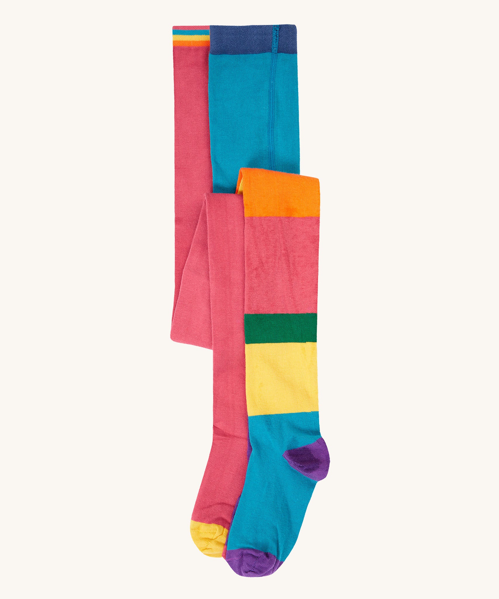 A 2 pack of Frugi Norah organic cotton footed kids tights. One pair has a multi-colour hotchpotch colour block design the other has a solid rose pink colour with multi-coloured waistband. 