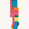 A 2 pack of Frugi Norah organic cotton footed kids tights. One pair has a multi-colour hotchpotch colour block design the other has a solid rose pink colour with multi-coloured waistband. 