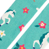 Close up of the Frugi children's Norah organic cotton knitted tights in moss green with unicorns.
