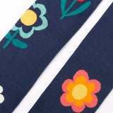 Close up of the Frugi children's Norah organic cotton knitted tights in navy blue with flowers.