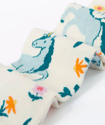 Frugi children's Norah organic cotton knitted tights in white with pegasus and flowers patterns.