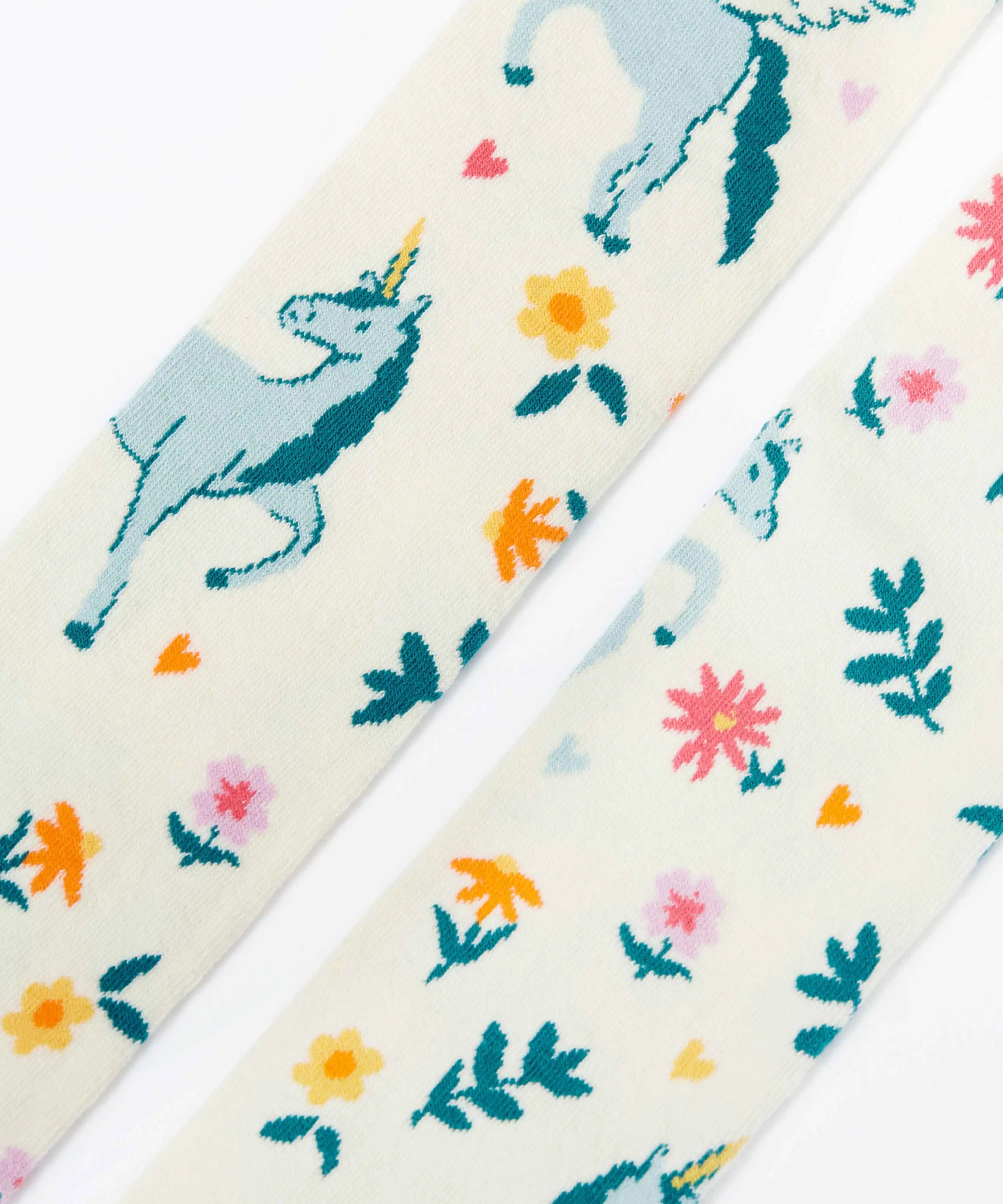 Frugi children's Norah organic cotton knitted tights in white with pegasus and flowers patterns.