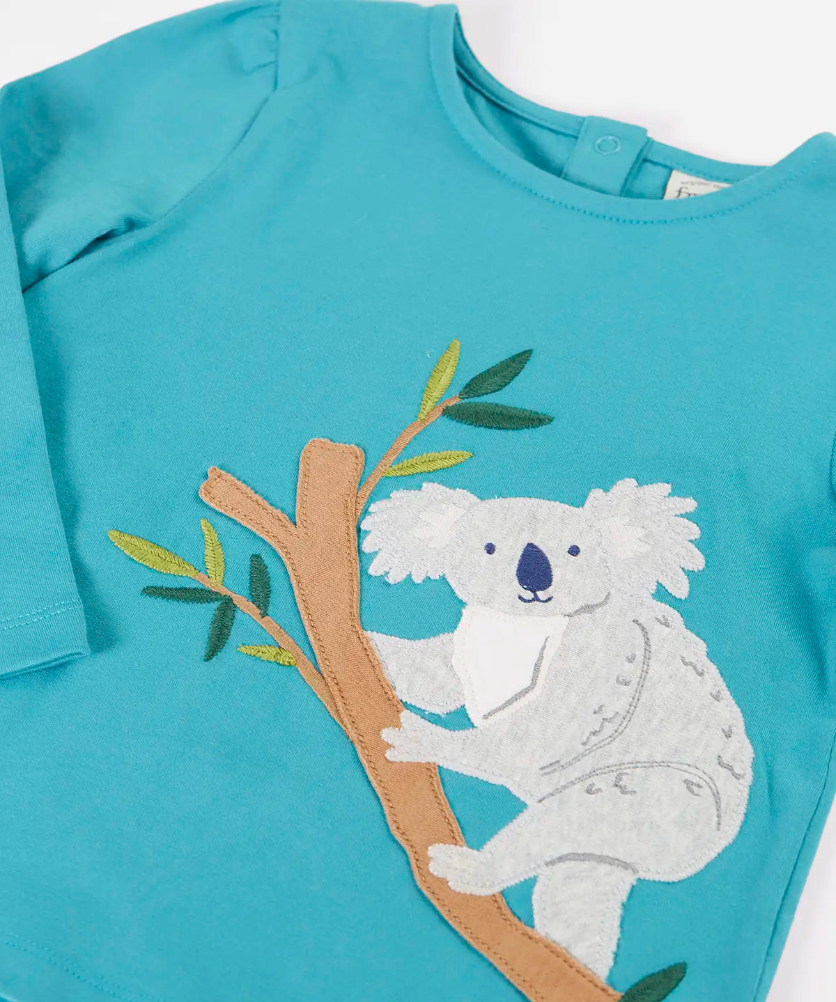 Frugi Ola outfit showing a close up a koala applique on the light blue organic cotton top and poppers on the back for easy dressing