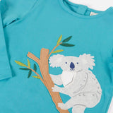 Frugi Ola outfit showing a close up a koala applique on the light blue organic cotton top and poppers on the back for easy dressing