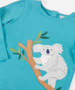 Frugi Ola outfit showing a close up a koala applique on the light blue organic cotton top and poppers on the back for easy dressing