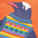 Close up of the penguin applique on the salamander orange Frugi organic cotton superb sweatshirt .