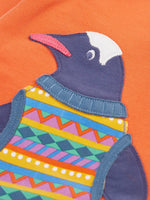 Close up of the penguin applique on the salamander orange Frugi organic cotton superb sweatshirt .