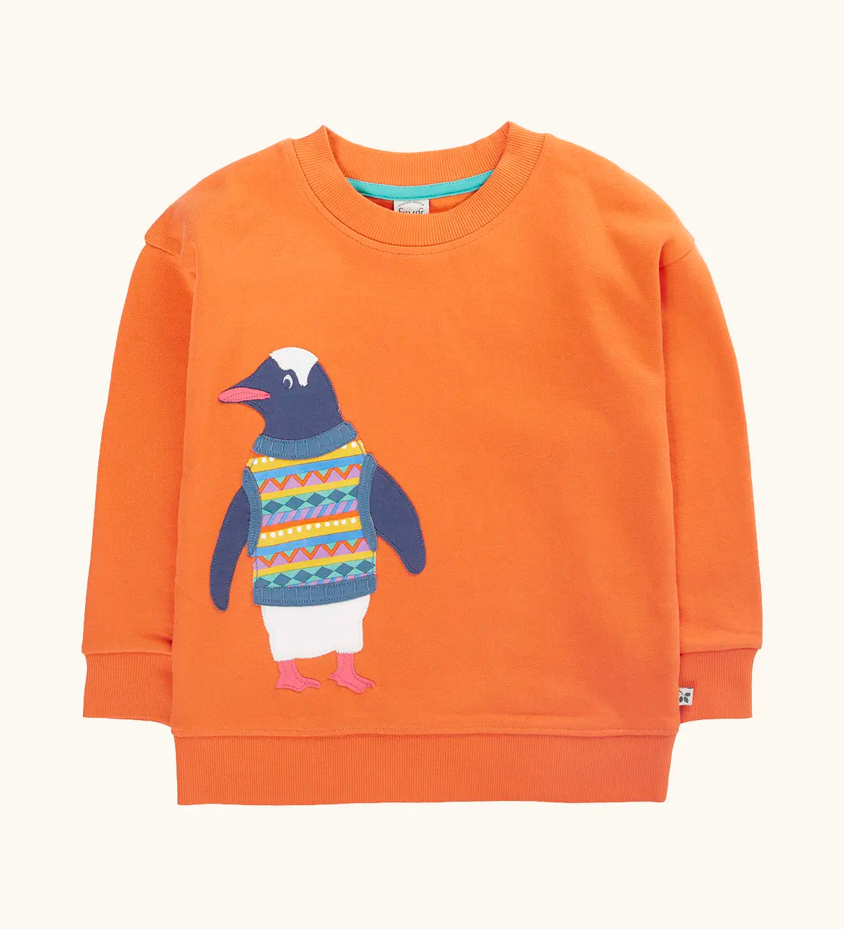 Frugi organic cotton superb sweatshirt salamander orange with penguin applique. The penguin is wearing a fairisle style tank top. 
