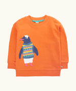 Frugi organic cotton superb sweatshirt salamander orange with penguin applique. The penguin is wearing a fairisle style tank top. 