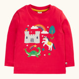 Frugi red organic cotton adventure magic applique top. Long sleeved top with castle, rainbow, tree horse and nessie appliques on the front. 