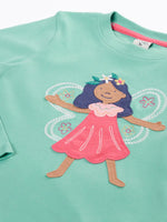 Close up of the front Frugi organic cotton adventure circular long sleeve top in moss green with fairy applique.