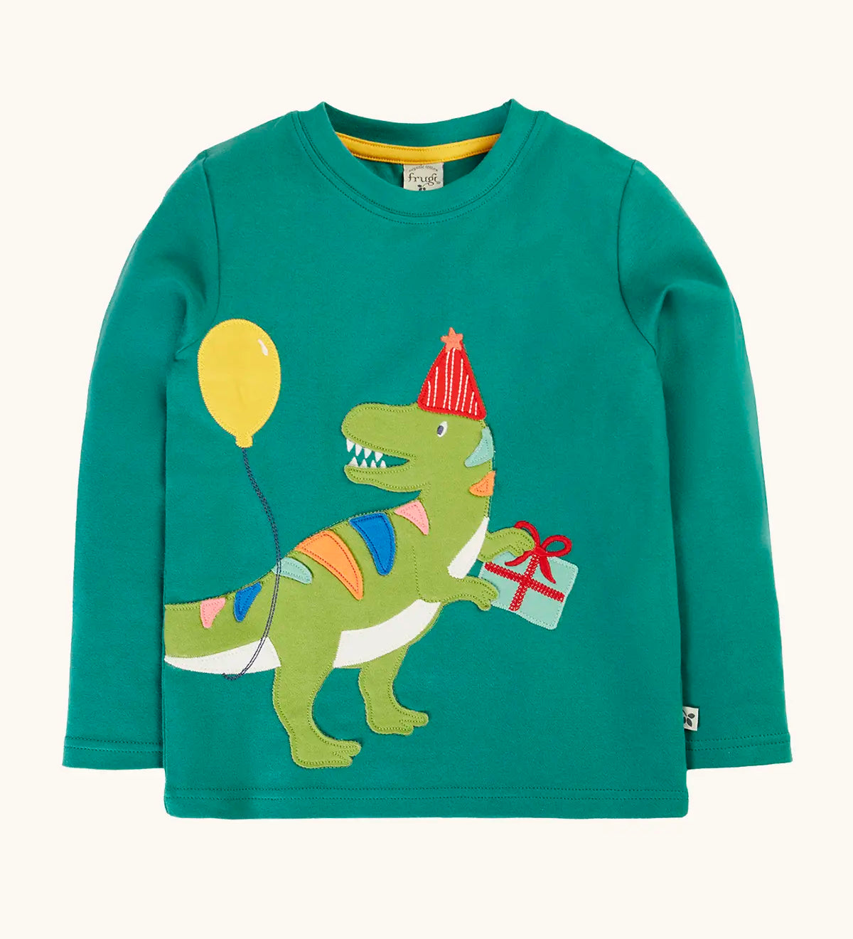 Frugi organic cotton adventure long sleeve hut green child's top with t-rex dinosaur wearing a party hat carrying a present with a yellow balloon appliques on the front.