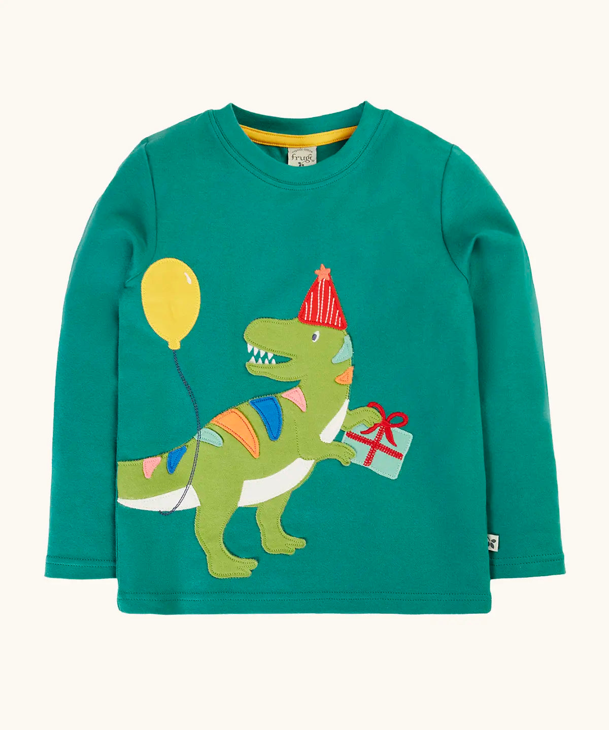 Frugi organic cotton adventure long sleeve hut green child's top with t-rex dinosaur wearing a party hat carrying a present with a yellow balloon appliques on the front.